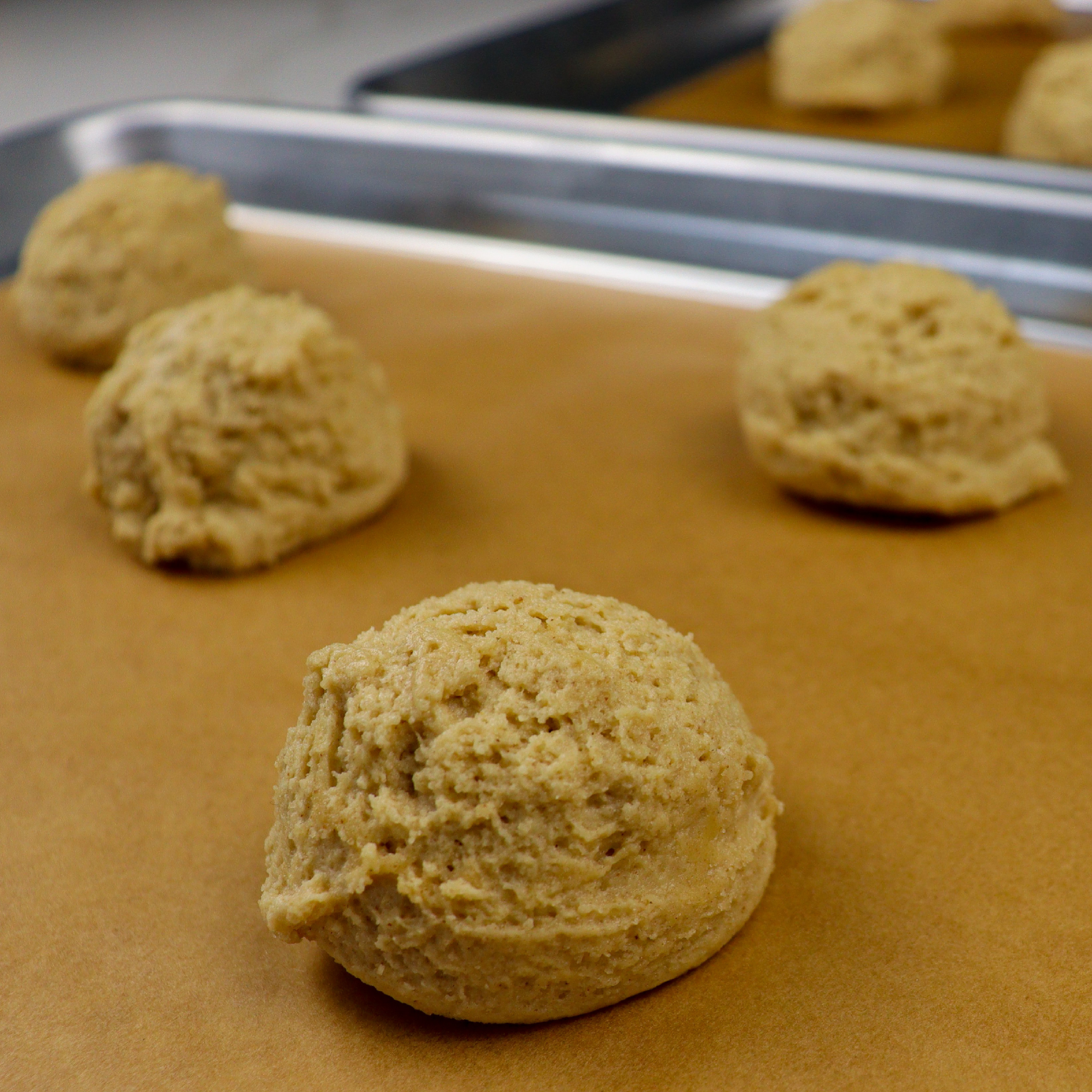 Peanut butter cookie dough scooped on baking sheets