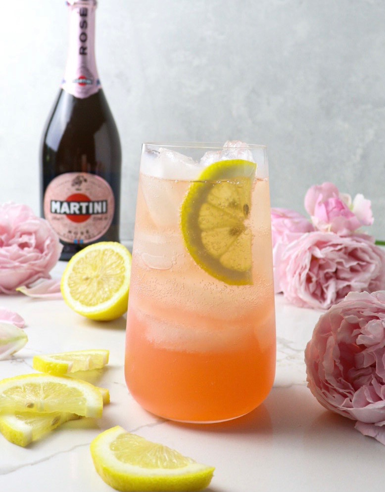Glass of sparkling rosé lemonade and bottle of sparkling rosé