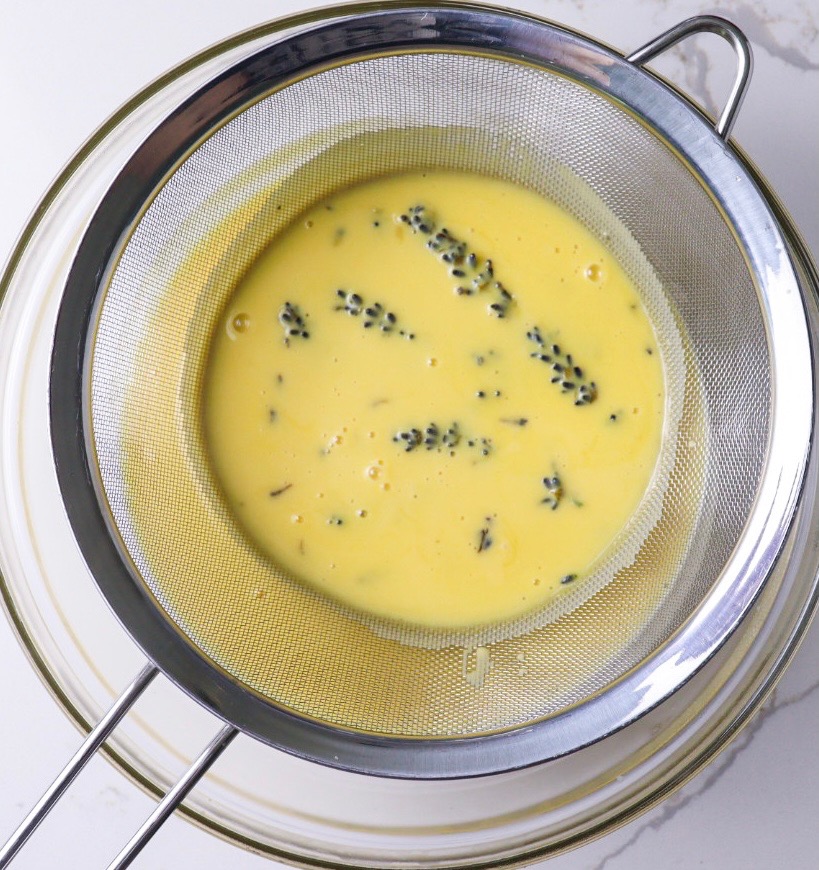 Straining the lavender cream through a sieve