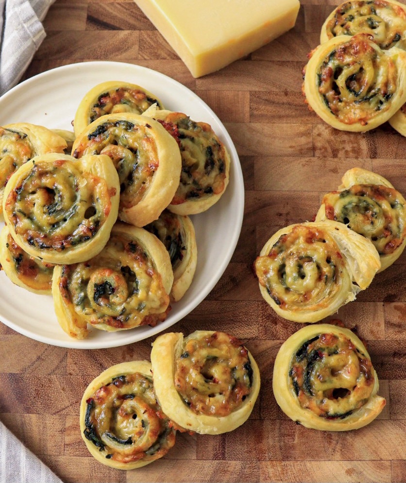 Plate of puff pastry pinwheels stuffed with swiss chard and Gruyère