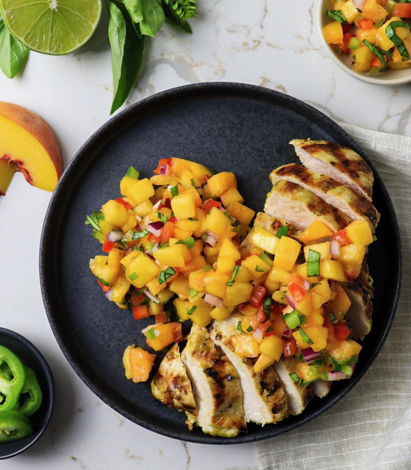 Plate of basil lime grilled chicken with peach salsa