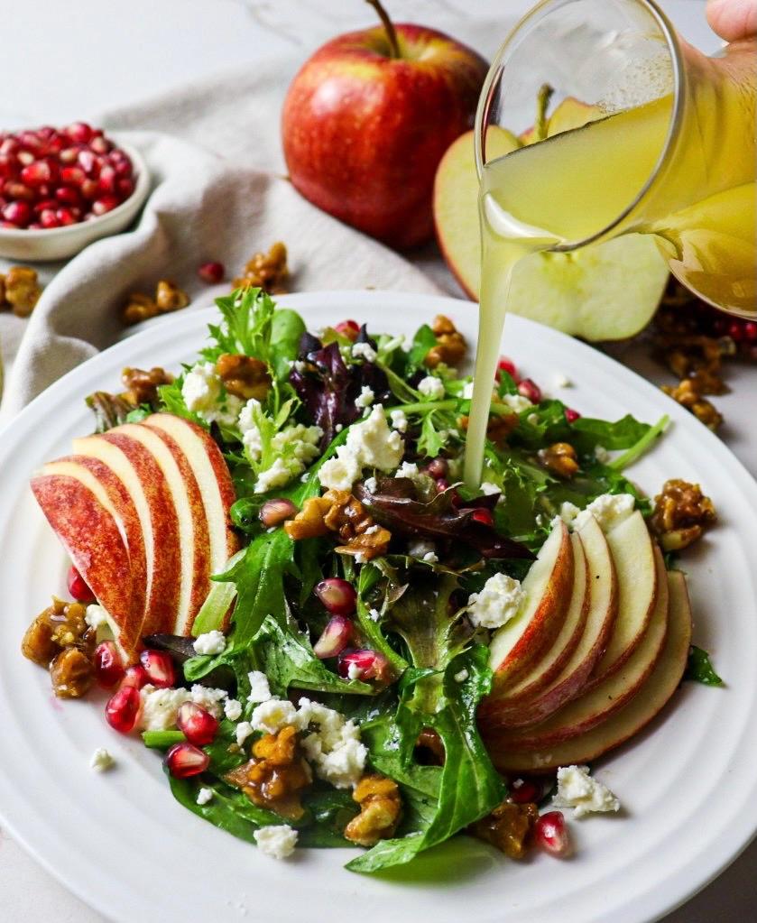 Maple cider vinaigrette poured over harvest apple salad