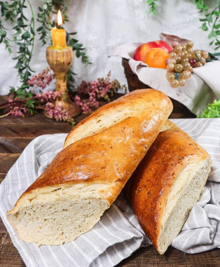A baguette of Hazelnut bread cut in half
