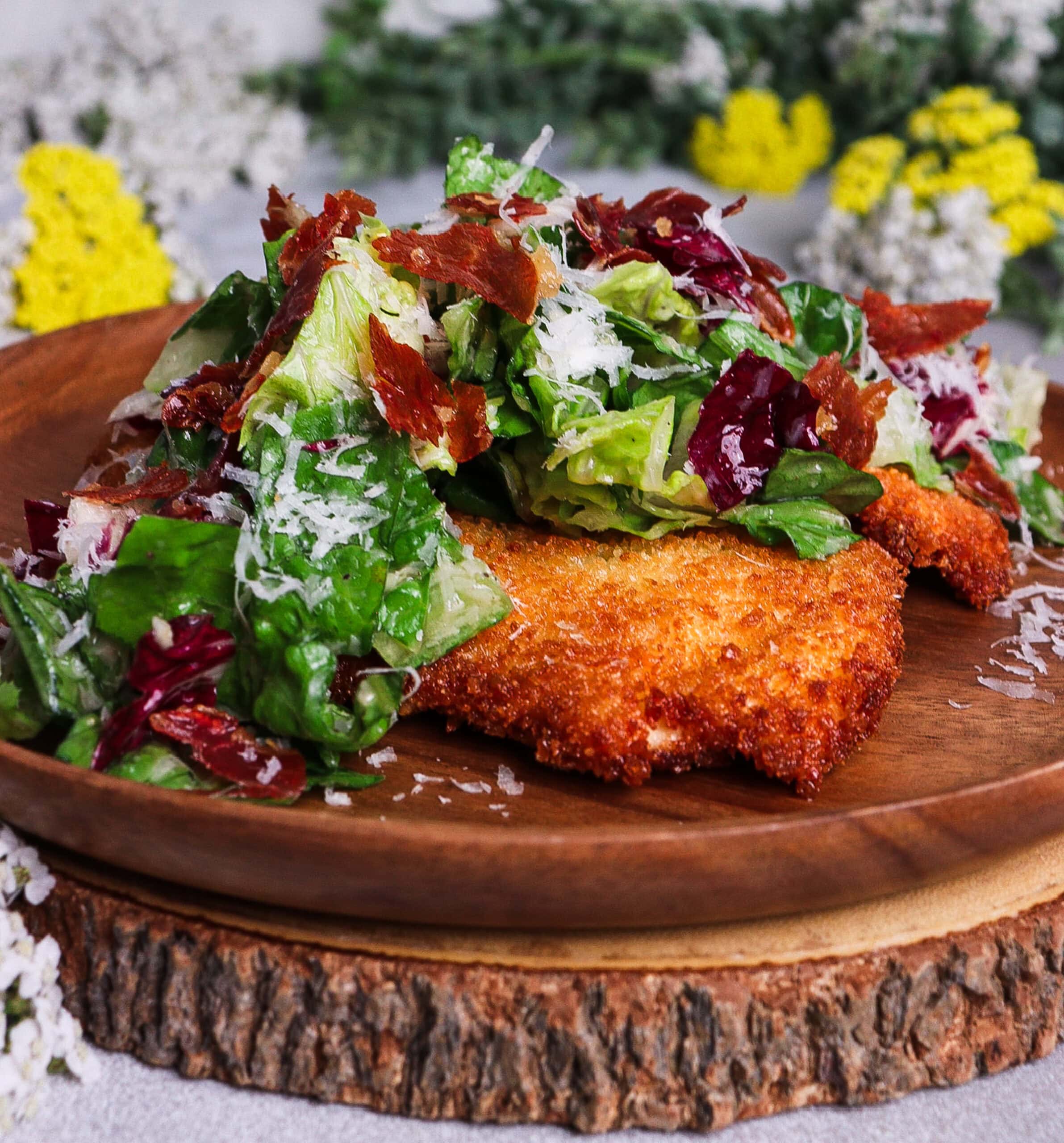 caesar salad crispy chicken, caesar salad with prosciutto, chicken milanese with caesar salad