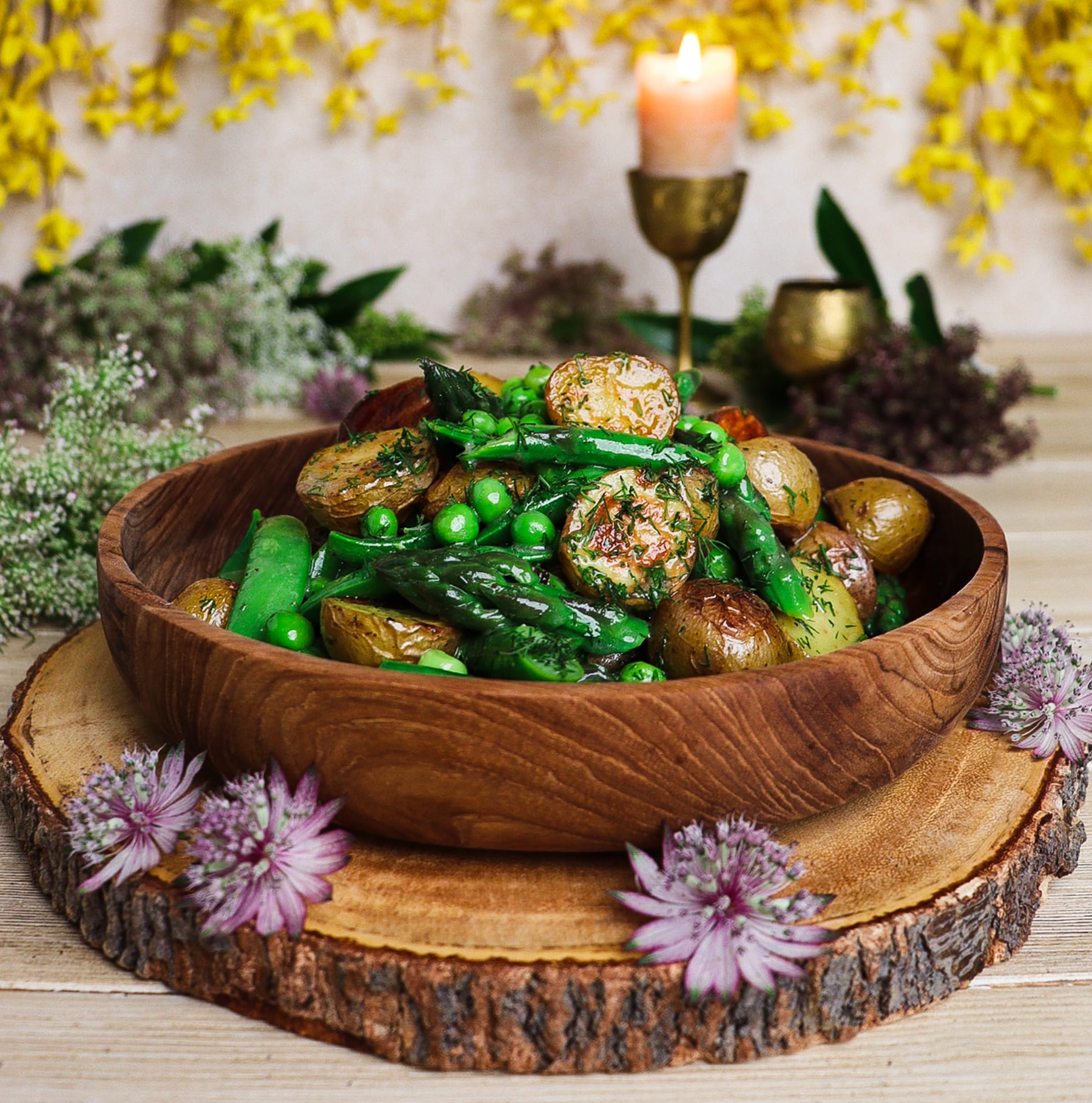 warm potato asparagus and pea salad in a rustic bowl and setting inspired by Lothlórien of Middle Earth