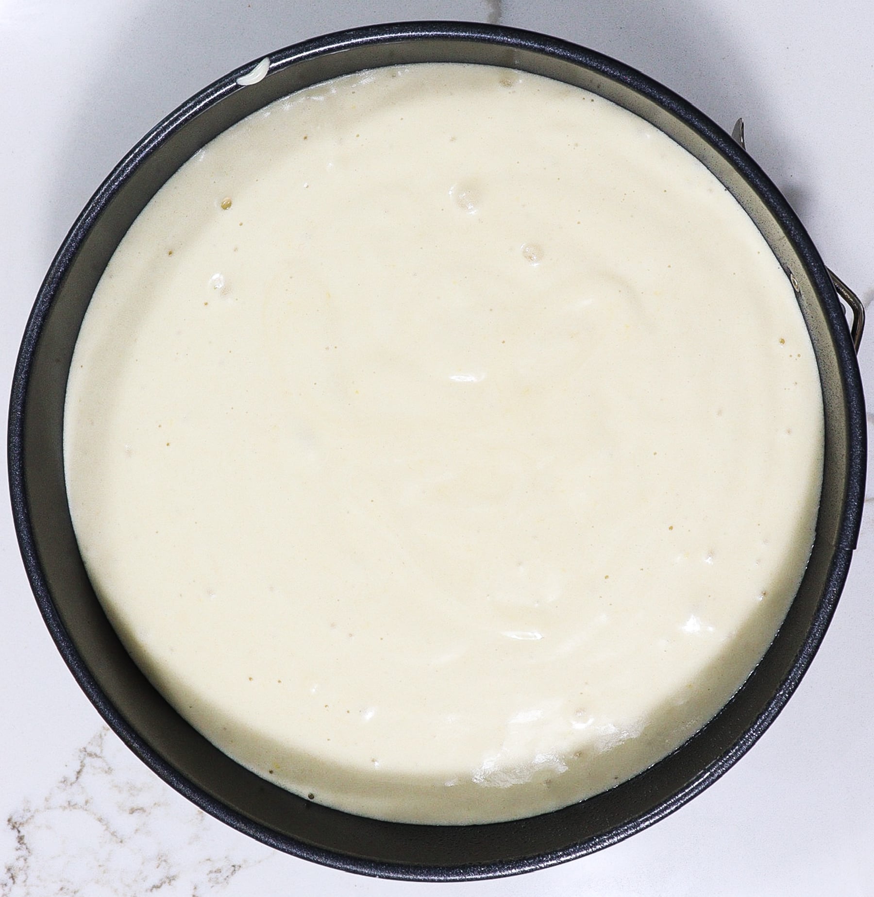 meadowsweet cream cake batter in a round cake pan before baking