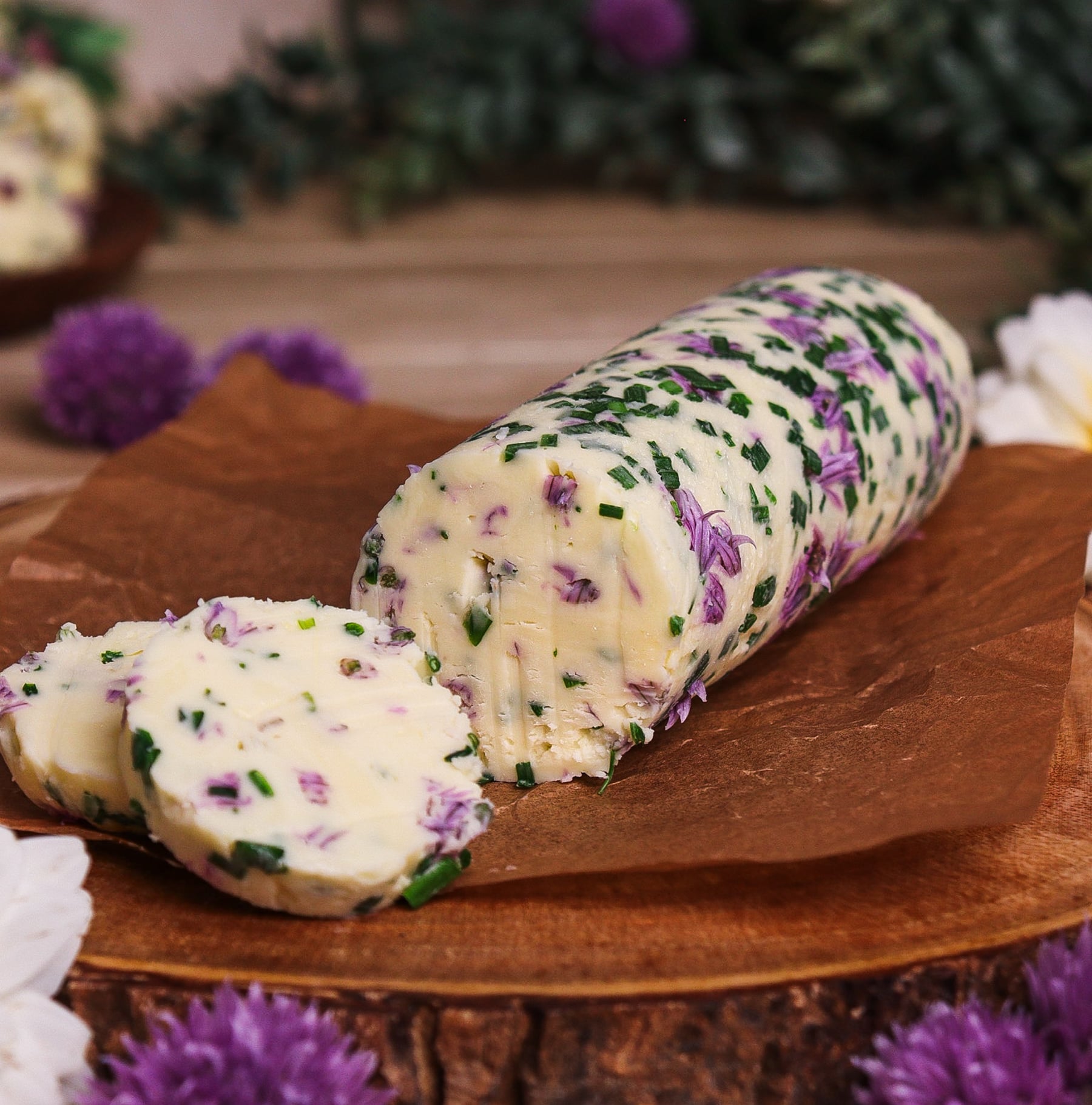 cylinder of chive blossom butter in a rustic setting inspired by Rivendell