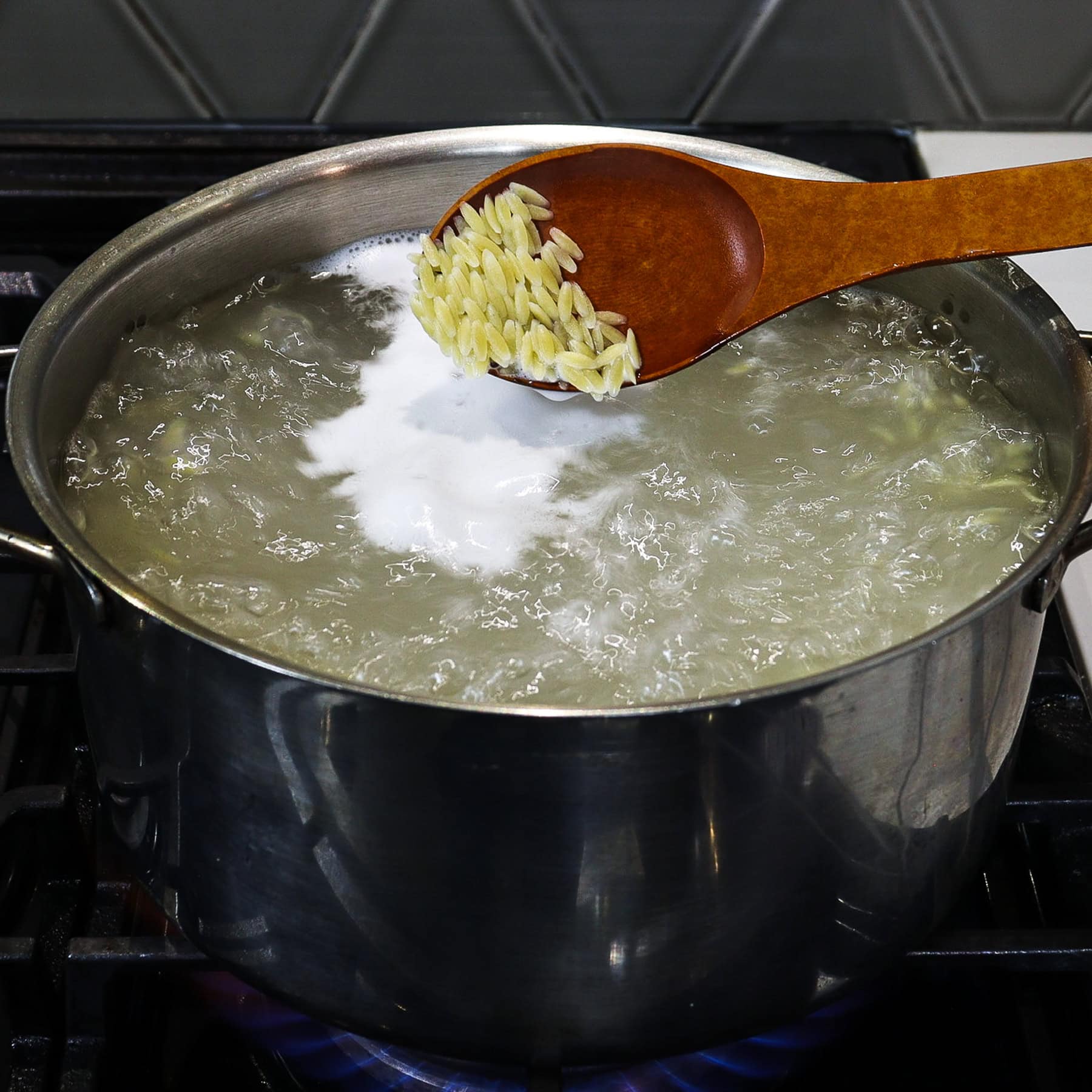 orzo pasta in a pot of boiling water stovetop
