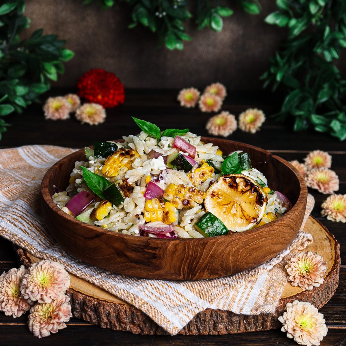 summer vegetable pasta with orzo and corn in a rustic bowl