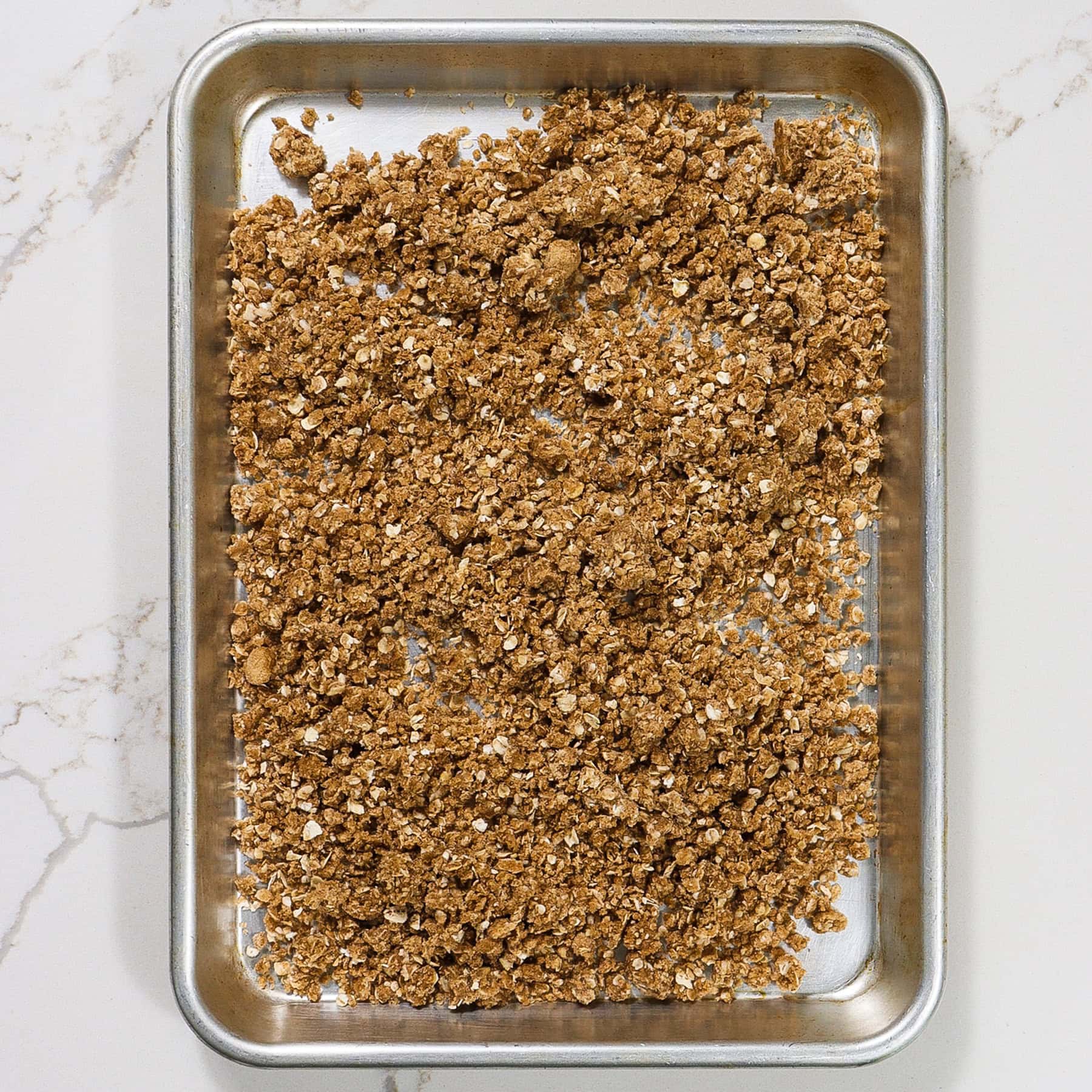 crumble topping for peach crisp waffles on a baking sheet
