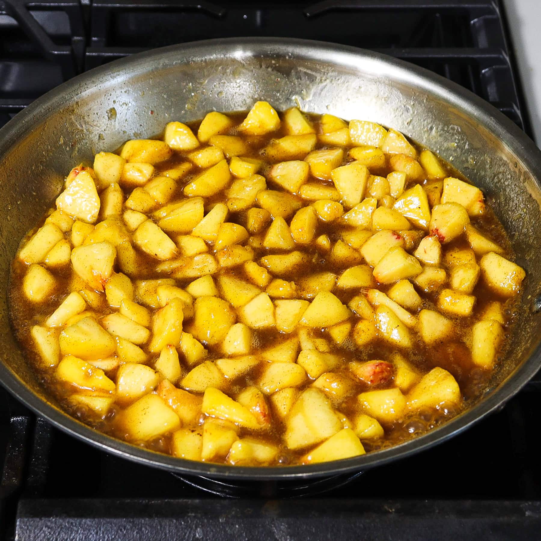 stewed peaches in butter and sugar on the stove