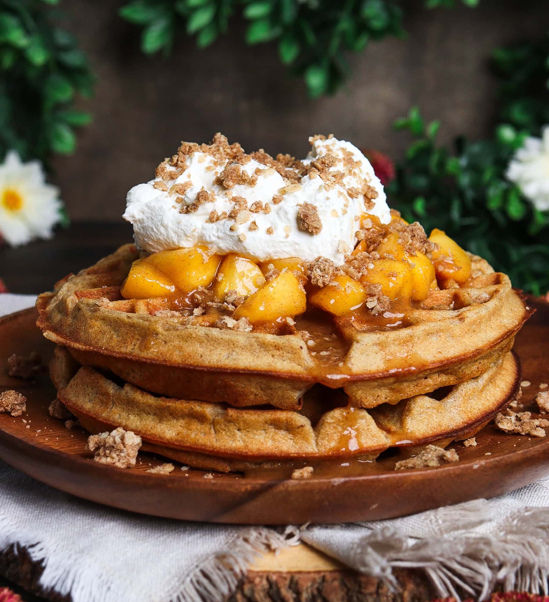 peach crisp waffles on a rustic platter