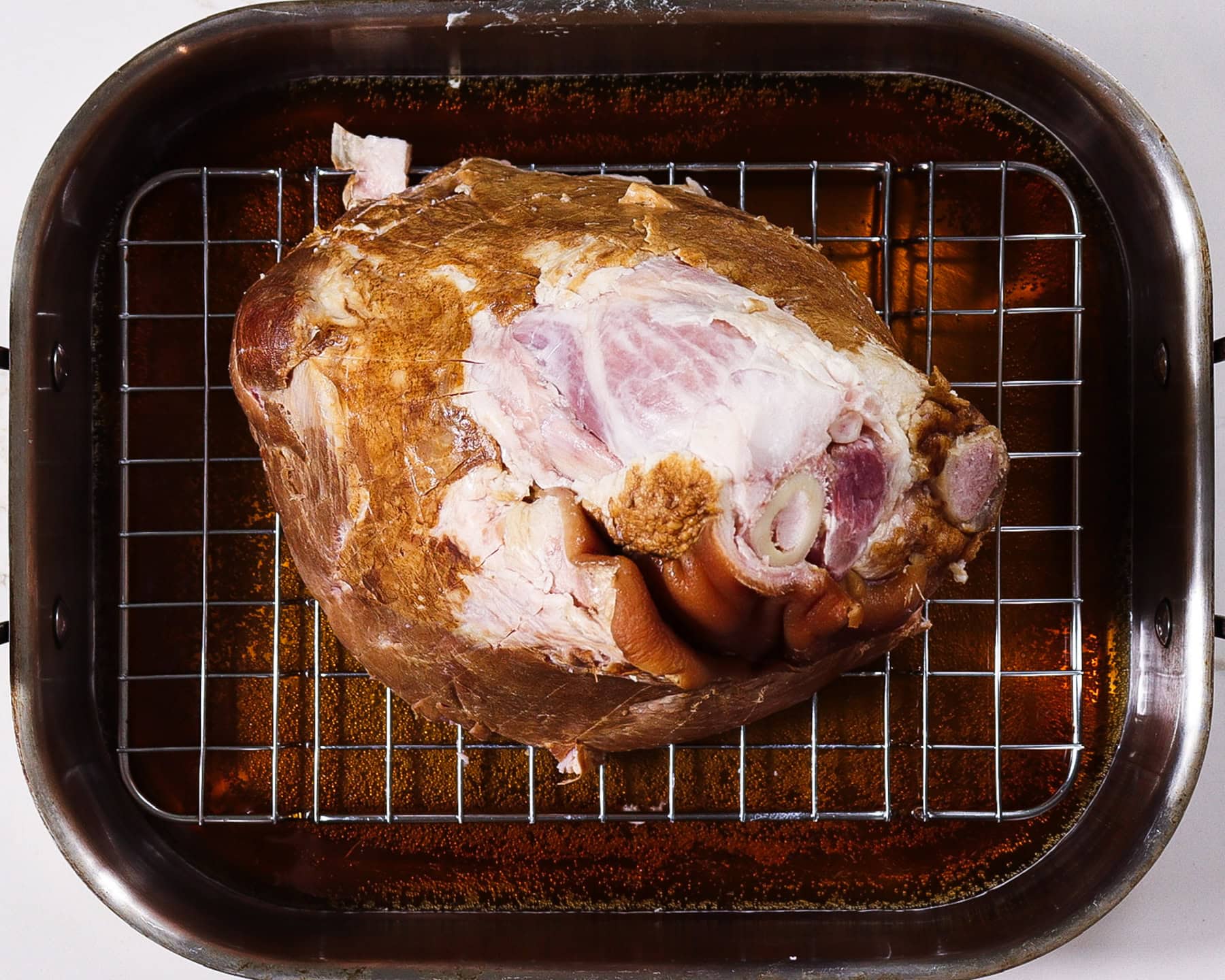 beer glazed ham in a roasting pan