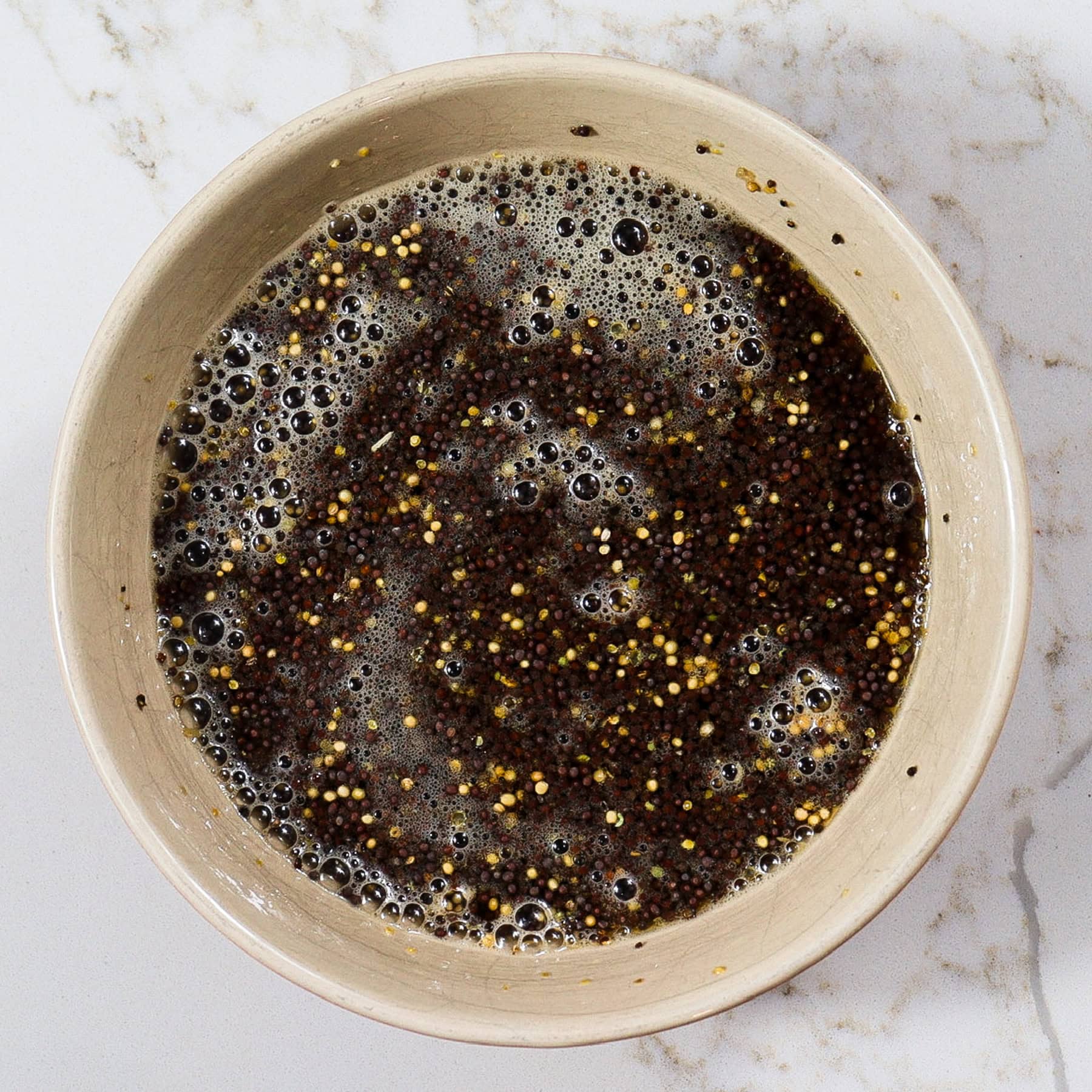 yellow and black mustard seeds soaking in beer