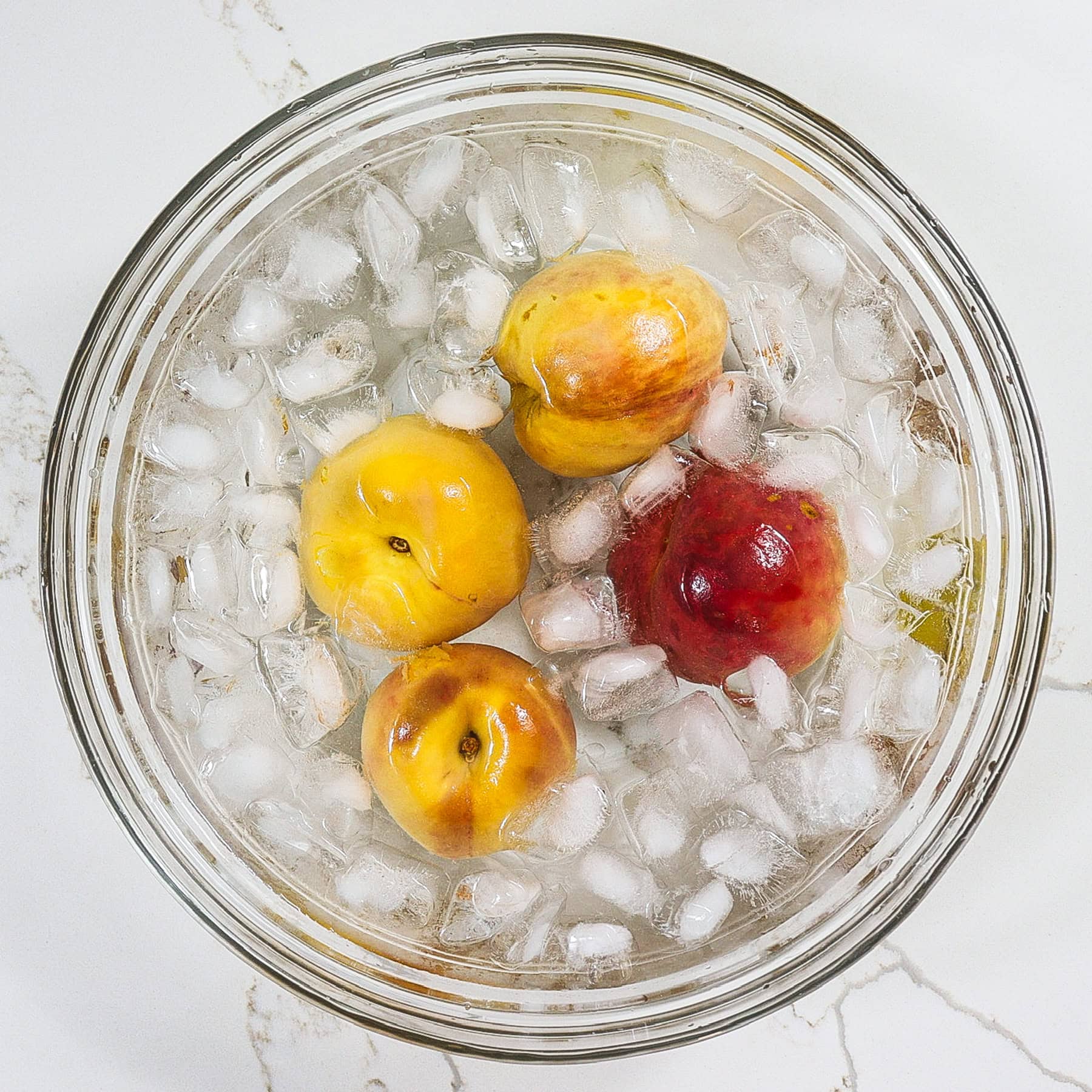 blanched peaches in an ice bath