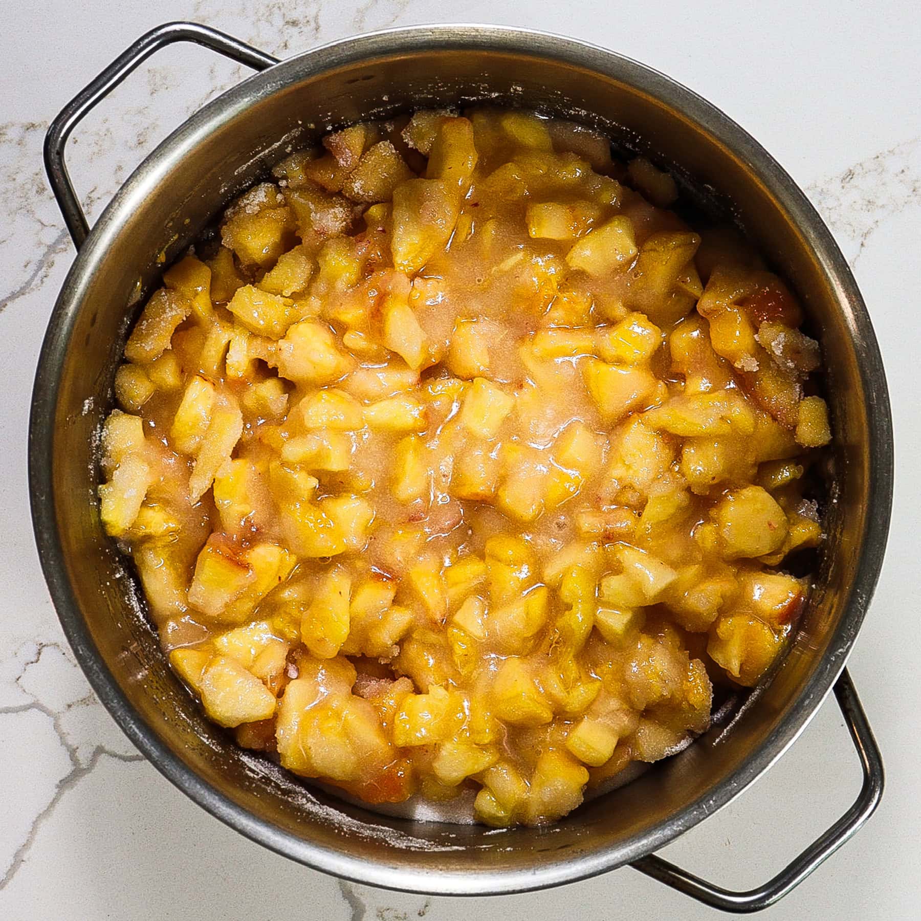 diced peaches mixed with sugar in a pot for homemade peach jam