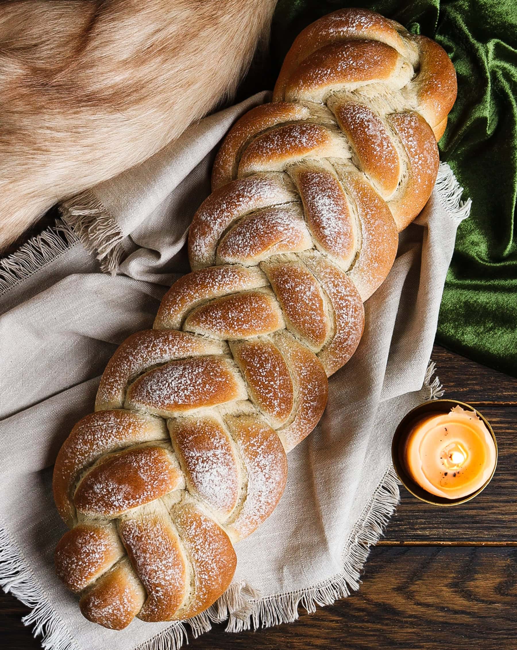 Loaf of barley bread with intricate braiding inspired by anglo-saxon patterns
