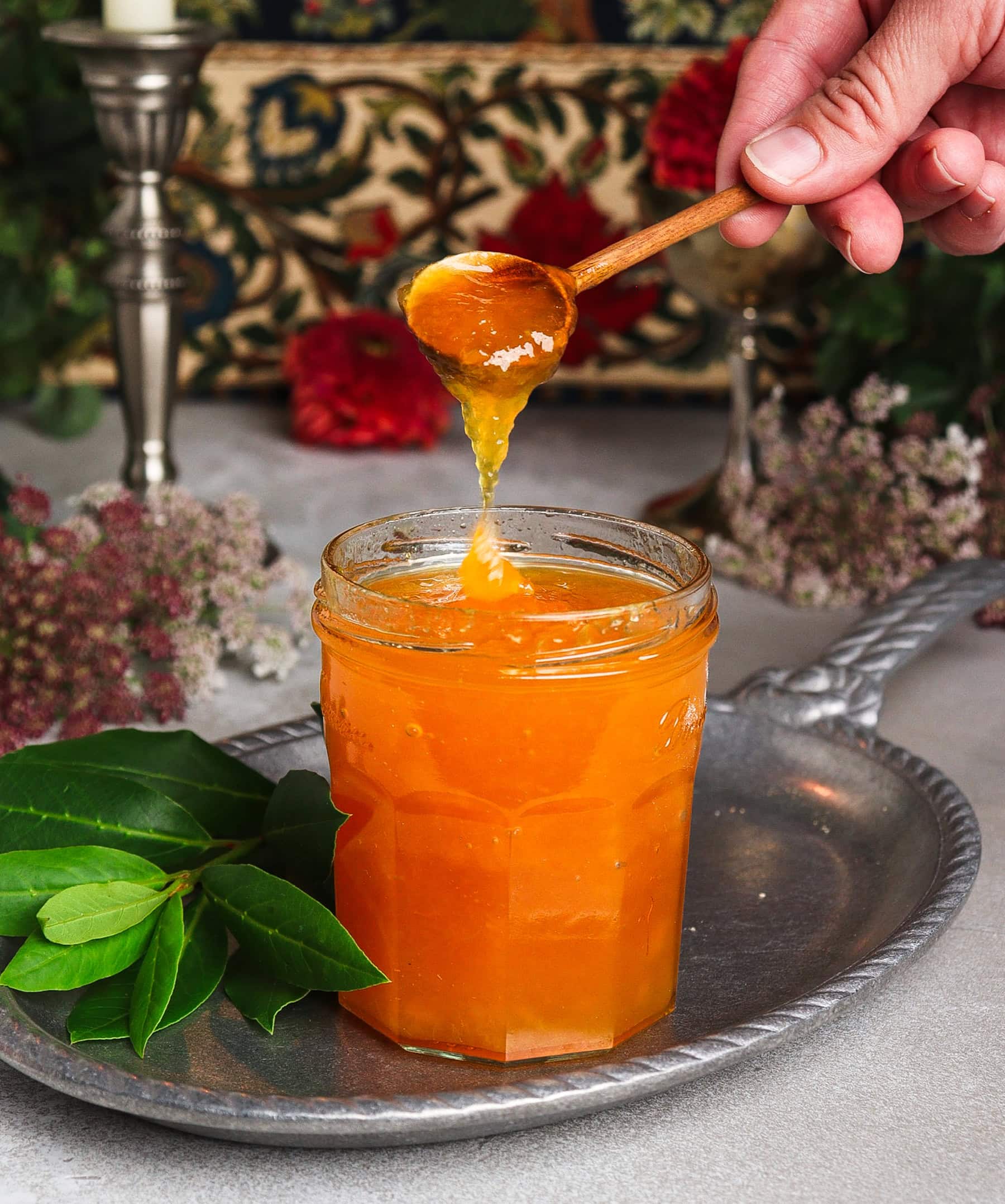 spoonful of homemade peach jam on a silver platter
