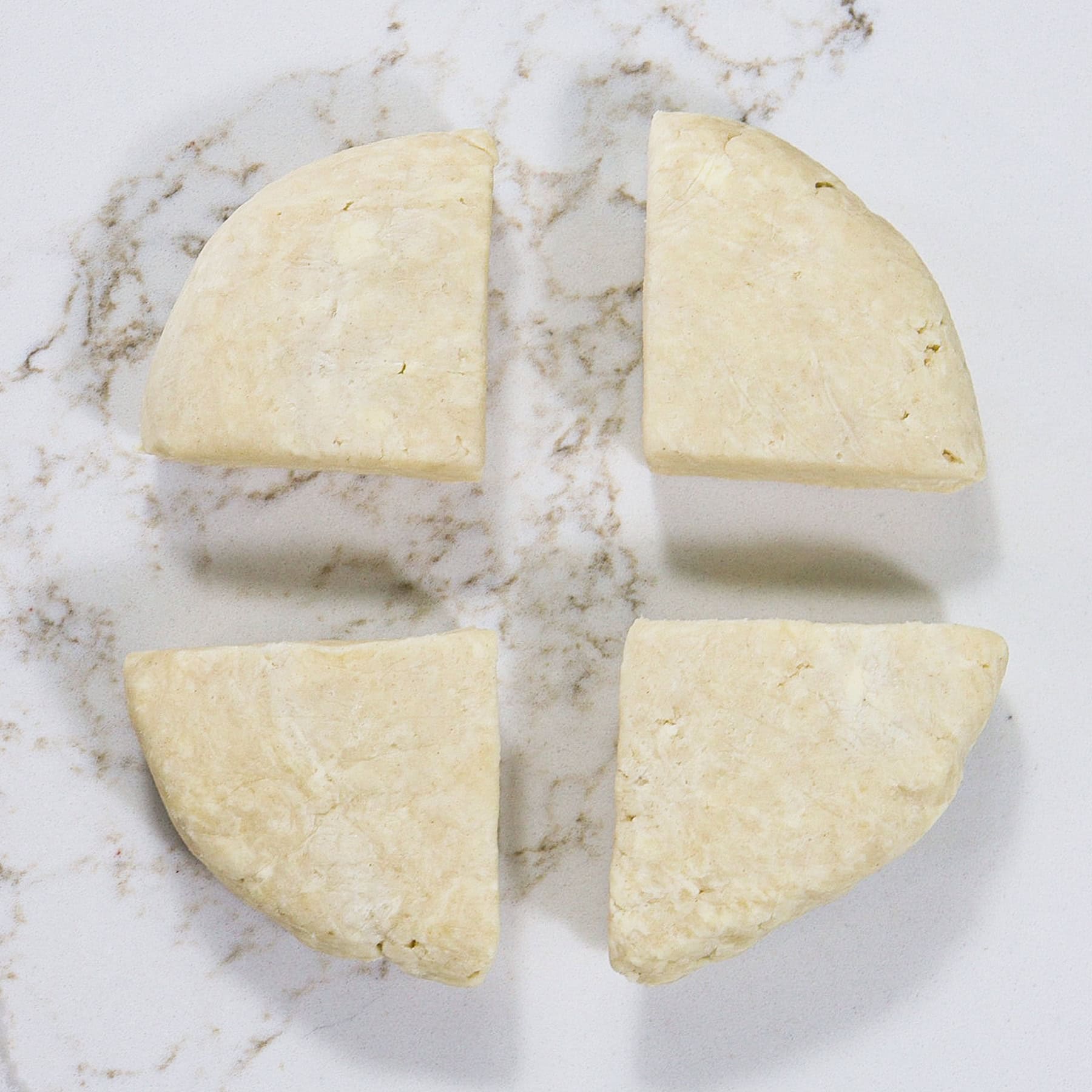 pie dough cut into quarters