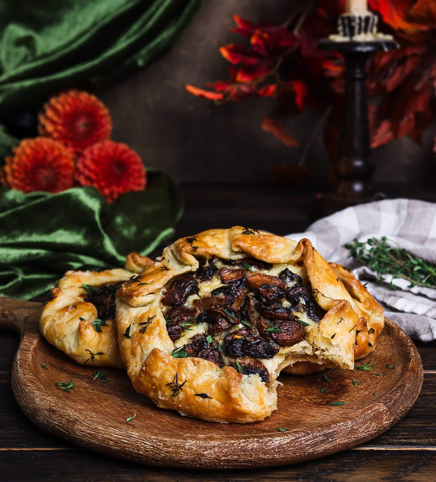 mushroom galette with a bite taken out of it on a rustic platter for a hobbit birthday