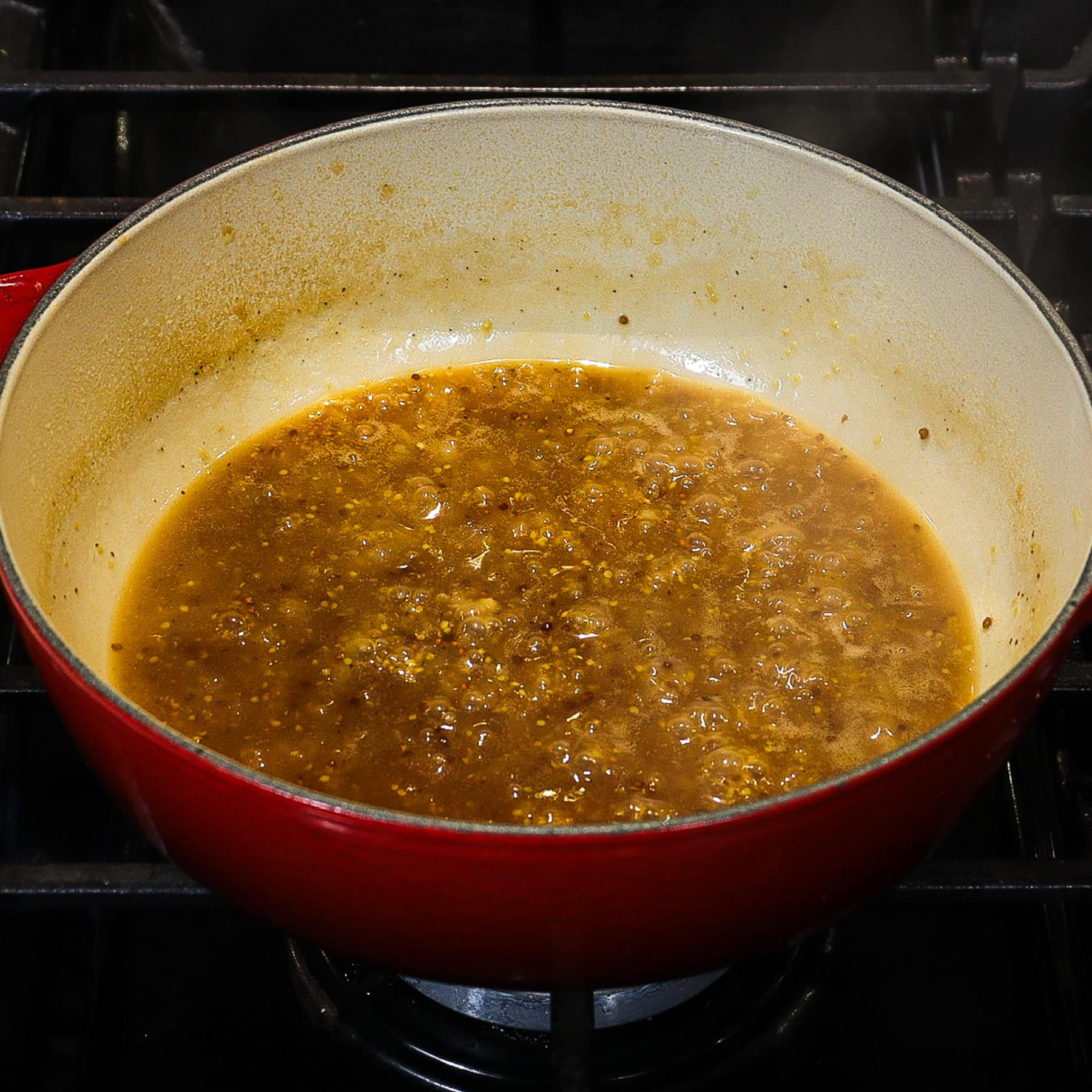 shallot and ale reduction simmering on a stovetop