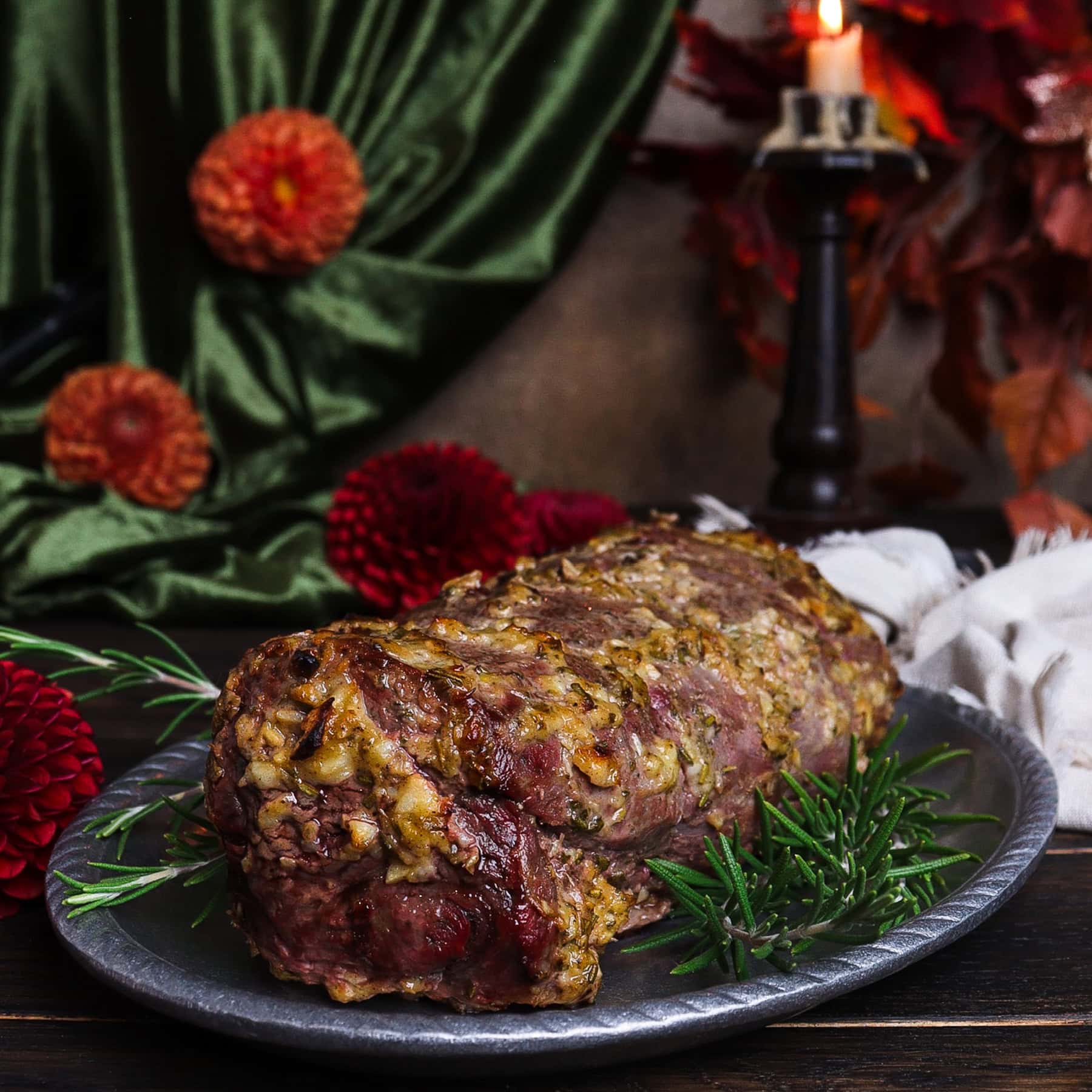 full beef tenderloin in a rustic setting on a silver platter