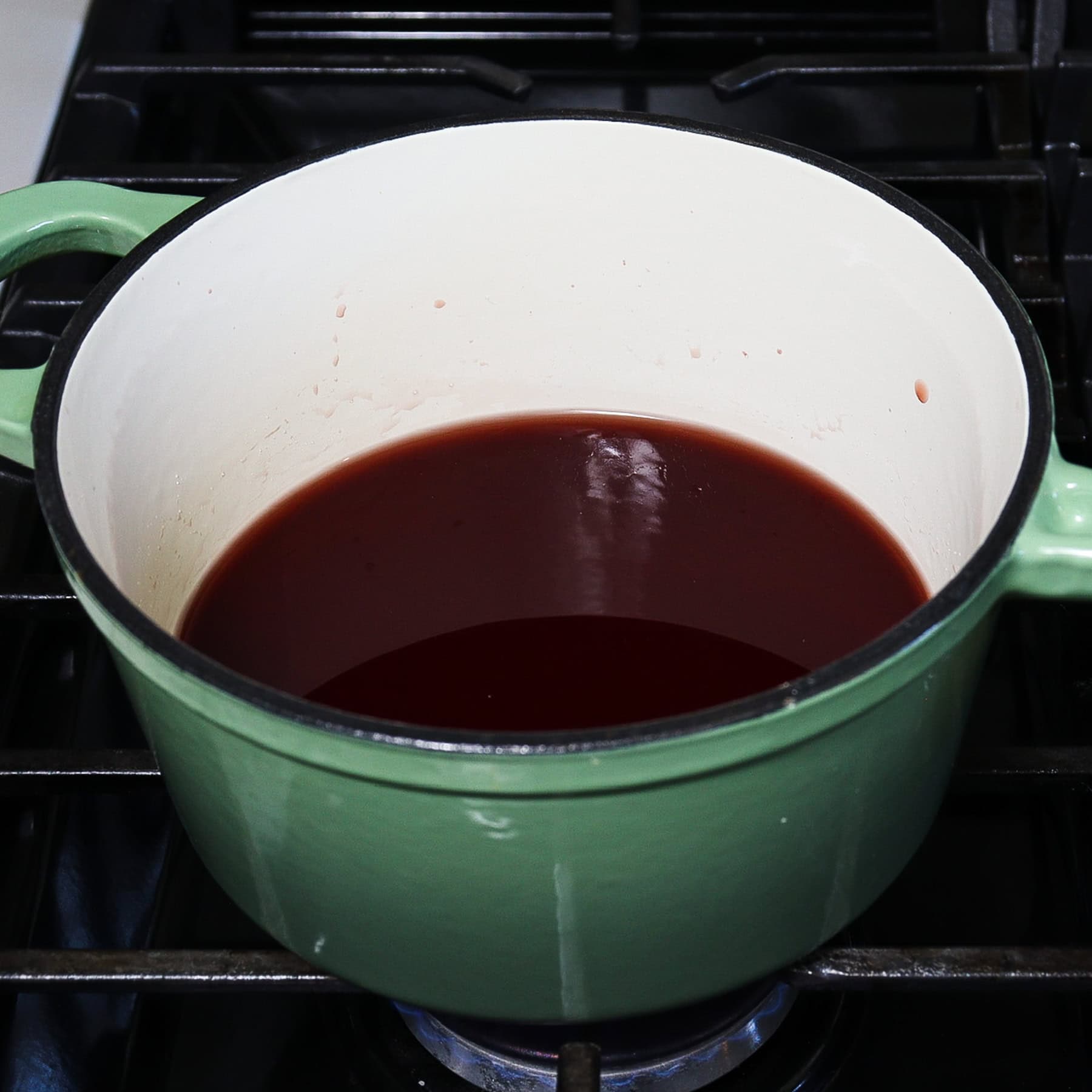 cherry syrup on stovetop for a slivovitz cocktail