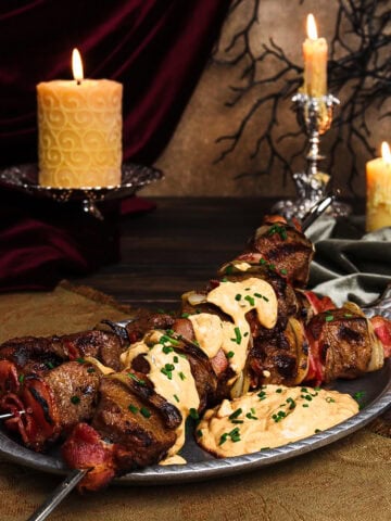robber steak skewers on a pewter dish in a Dracula-inspired set