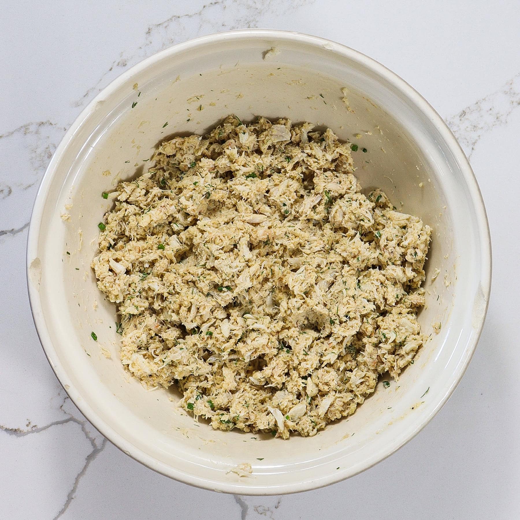 Mixture for crab cakes in a mixing bowl