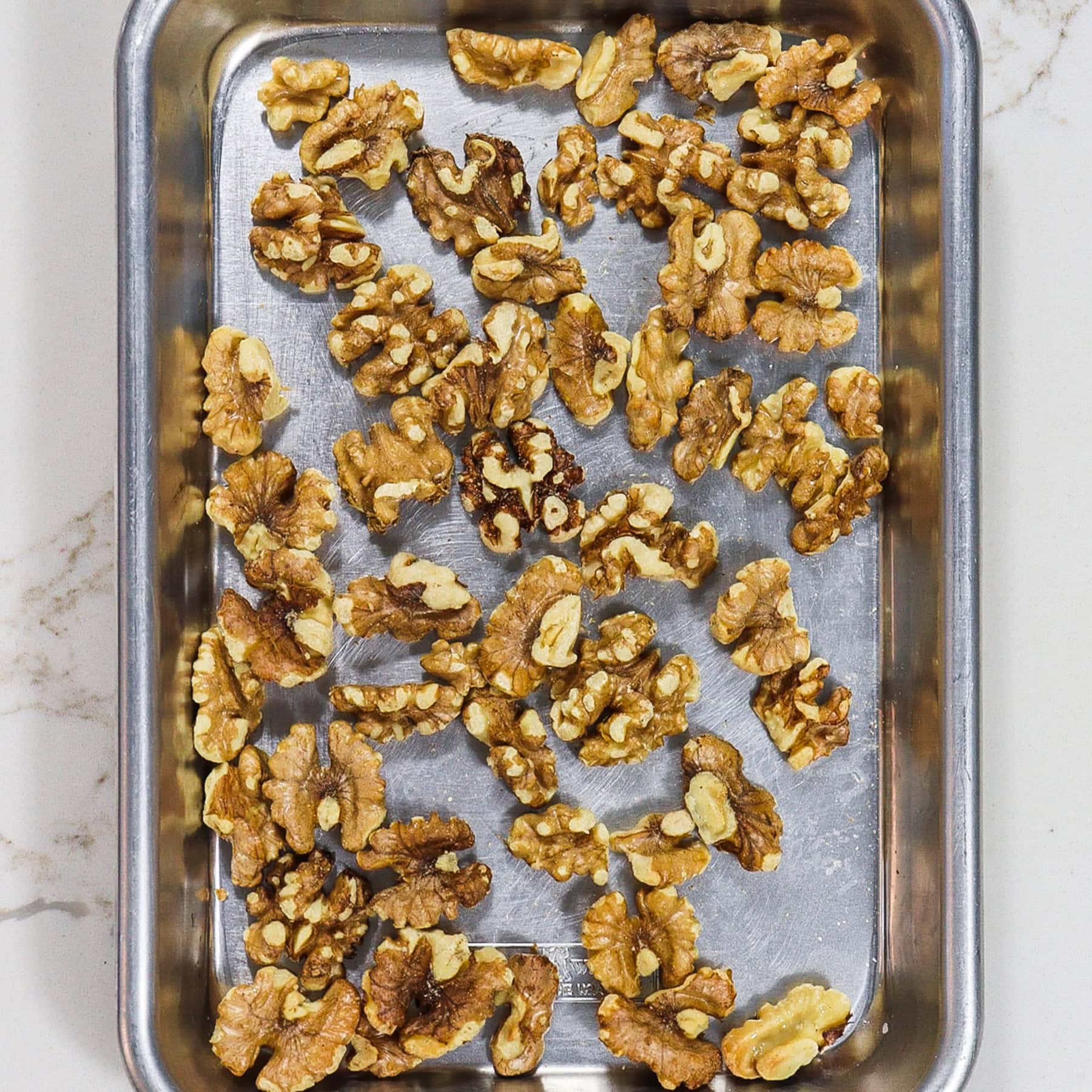 walnuts on a sheet pan for roasting