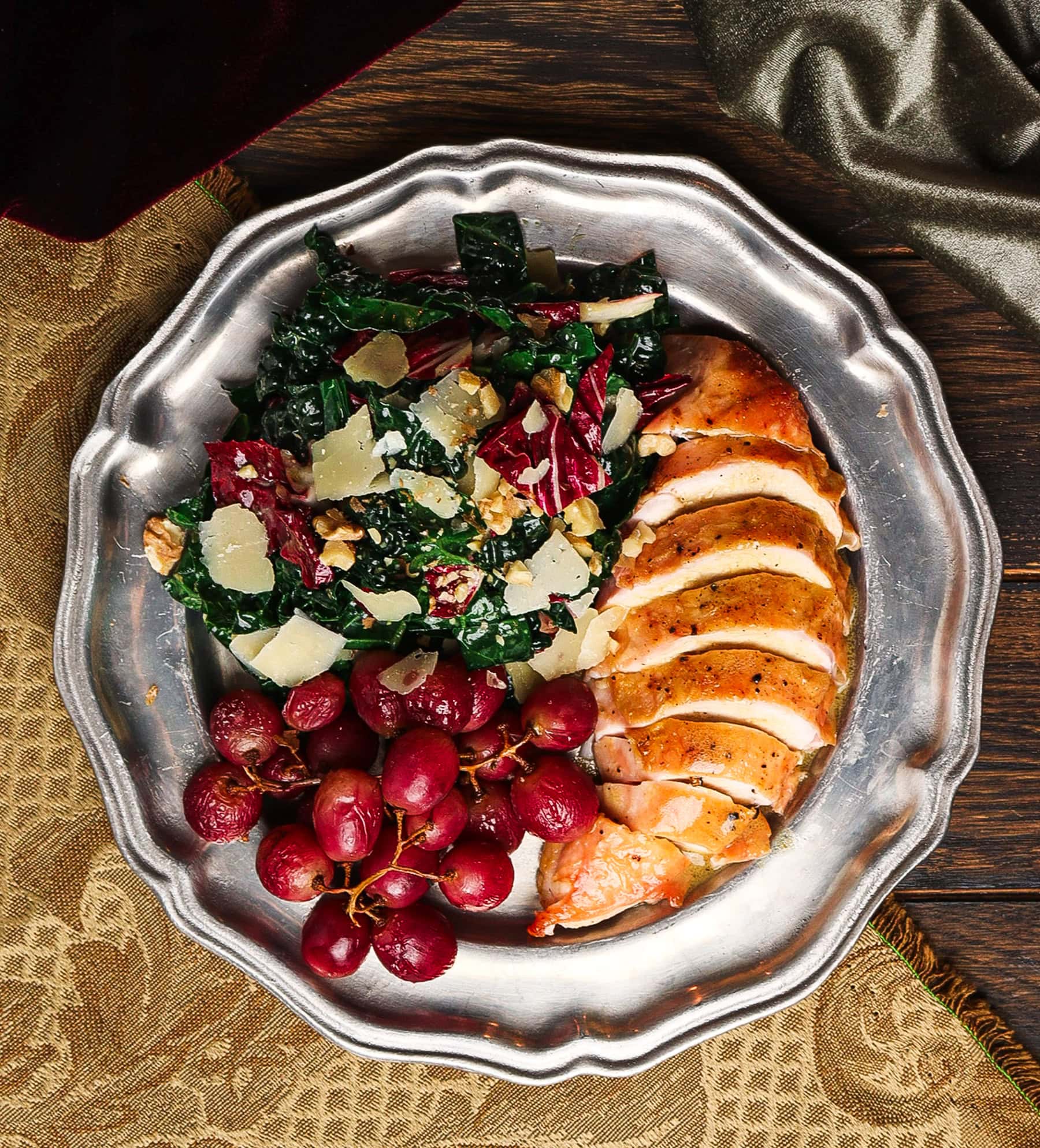 chicken with grapes with sweet wine vinaigrette on a silver platter for a dracula menu